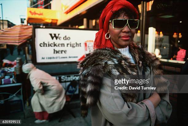Woman wearing fur coat and sunglasses, US, 1986.