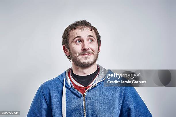 british male with a slight smile looking up - portraits studio smile stockfoto's en -beelden