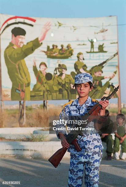 Child Soldier Holds Weapon