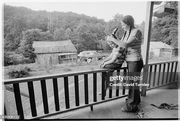 Woman Cutting Boy's Hair