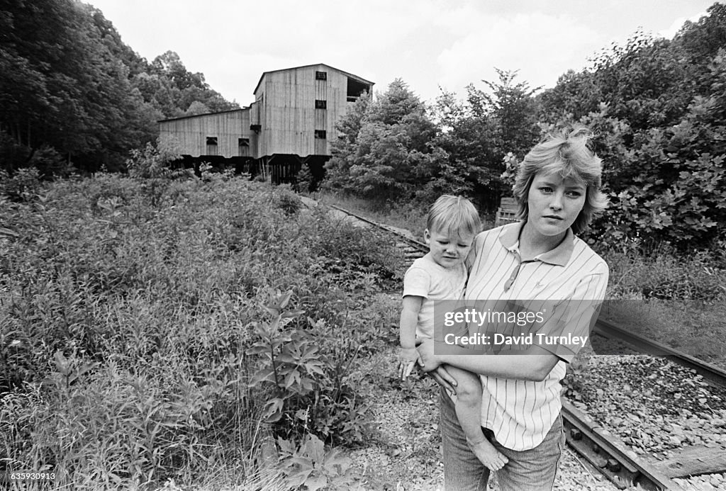 Young Mother with Son at Railroad Tracks