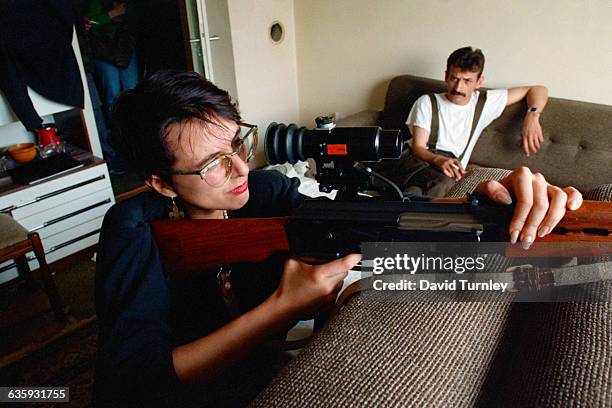 Bosnian sniper Nadia Jeriagic aims a rifle at Serbian snipers in the mountains from her position on the 20th floor of a Sarajevo building. Jeriagic,...