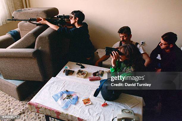 Bosnian snipers, including Nadia Jeriagic, at left, shoot at Serbian snipers in the mountains from their position on the 20th floor of a Sarajevo...