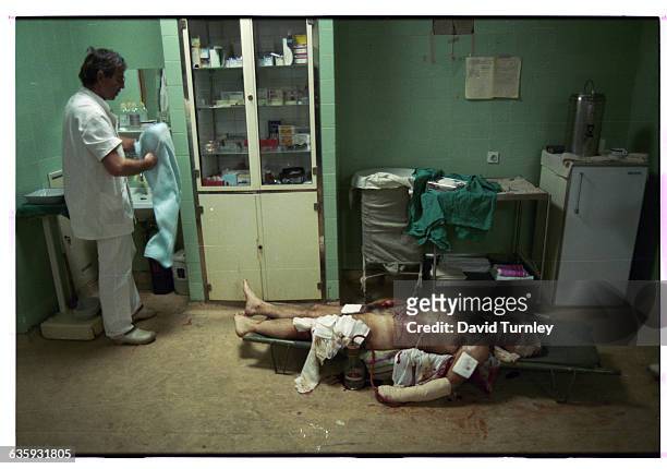 Victim of a Serbian bombing in the center of Sarajevo on the first day of a cease-fire lies seriously injured in a military hospital.