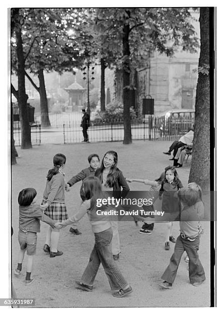 Young Children Playing Ring Around the Rosy