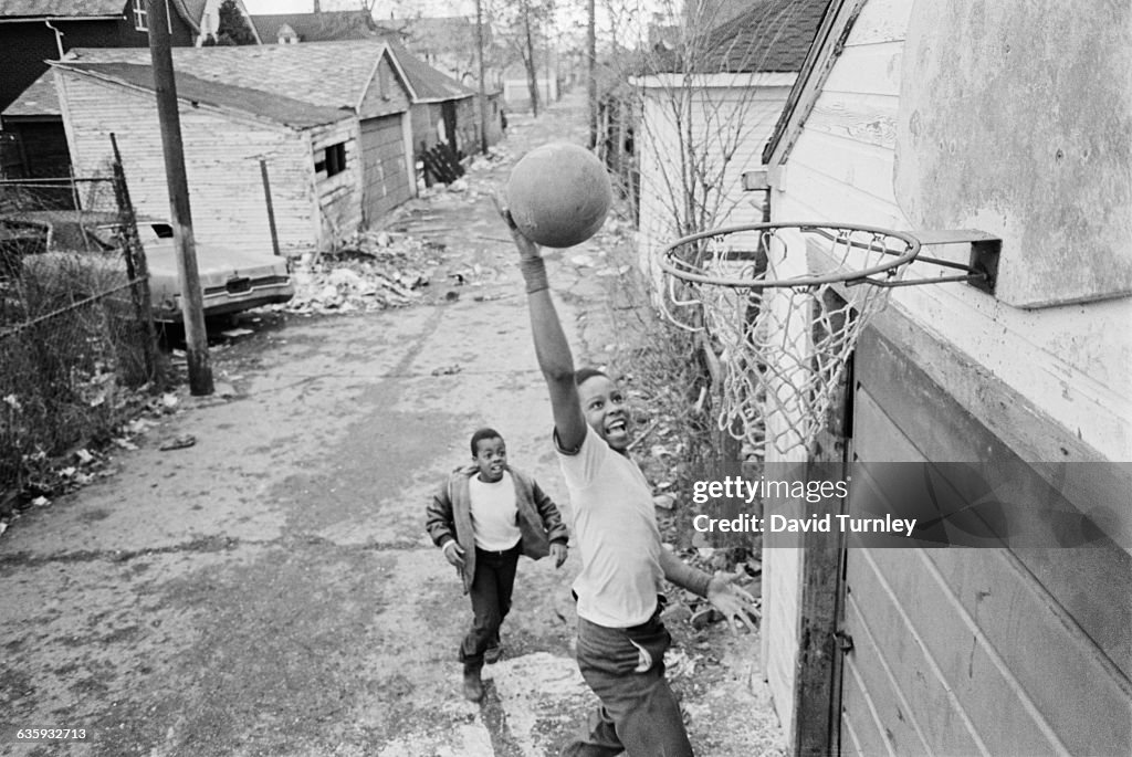 Boys Playing Basketball in an Alley