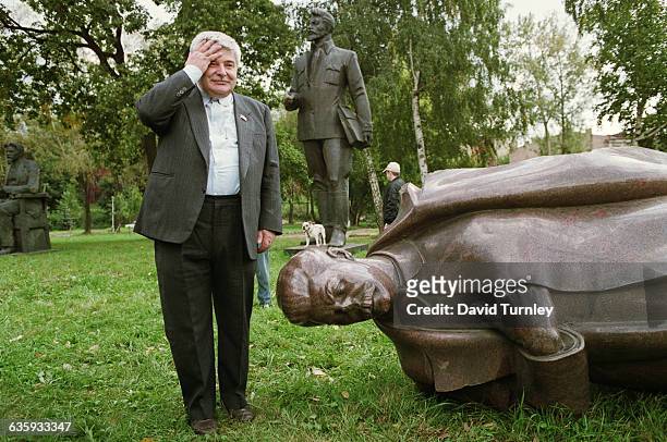 Man with Fallen Statue of Stalin