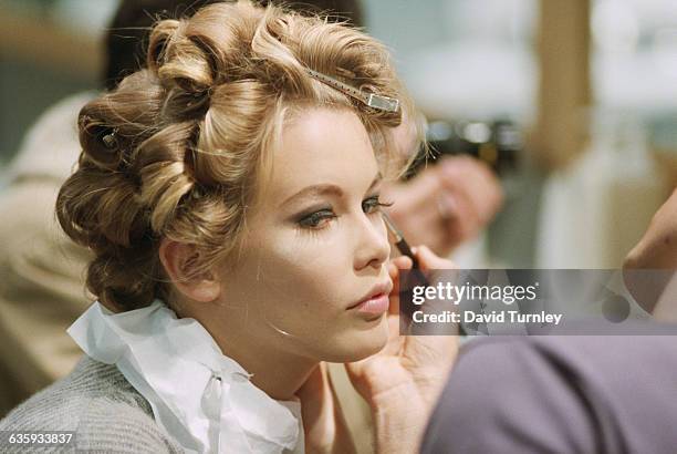 Model Claudia Schiffer gets her hair and makeup done for a fashion show at the Musee du Louvre in Paris, France.
