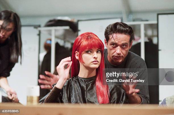 Fashion model Linda Evangelista dons a red wig for a fashion show at the Musee du Louvre in Paris, France. A celebrity hairstylist Oribe Canales...