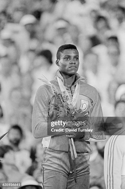 Carl Lewis stands with his hand over his heart as the American national anthem is played at the 1984 Summer Olympic Games, where Lewis won a total of...