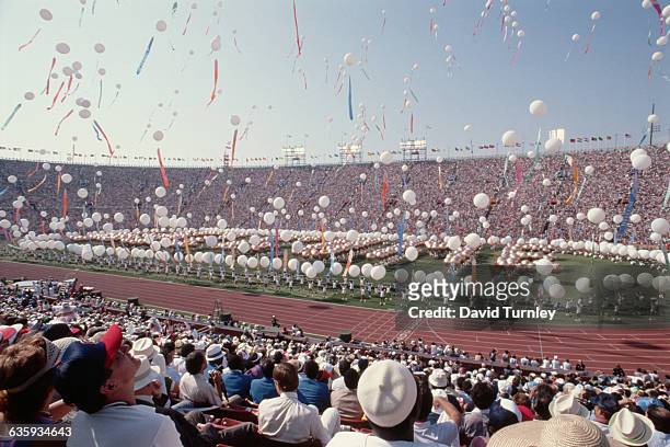Performers release hundreds of white balloons in the sky during the opening ceremony. Many communist nations boycotted the Games that year, notably...