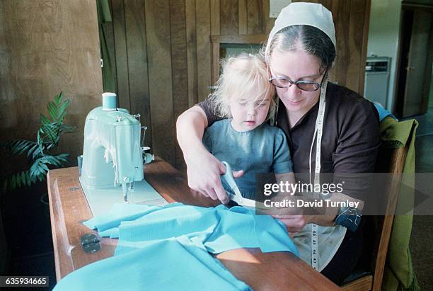 Amish Mother Sewing With Her Daughter