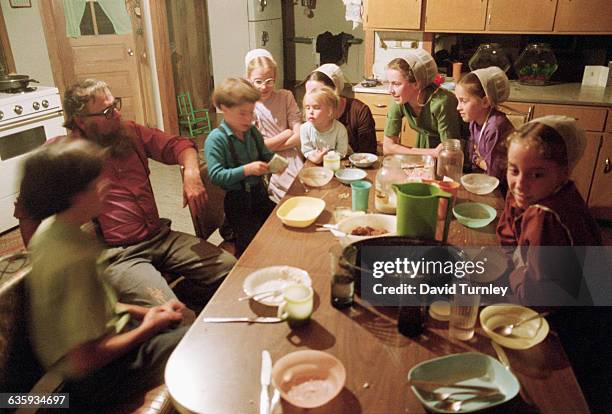 Amish Family Around the Kitchen Table