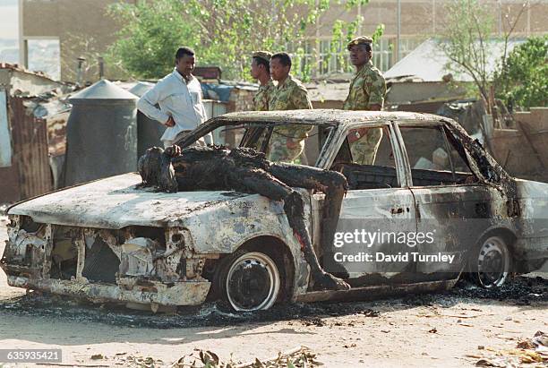 Dead Body of a Policeman on a Charred Vehicle