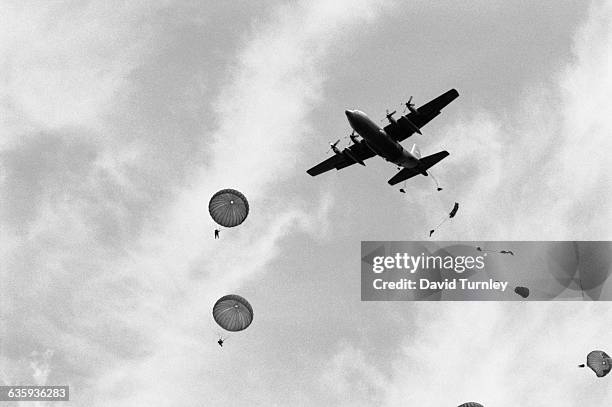 American World War II veteran paratroopers jump from a plane to commemorate the 50th Anniversary of the Normandy Invasion.