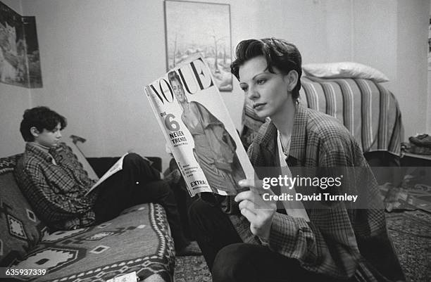 Adisa Vrabac, an aspiring model and veterinary student, reads Vogue magazine in her family's apartment in the Sarajevo neighborhood of Dobrinja. The...