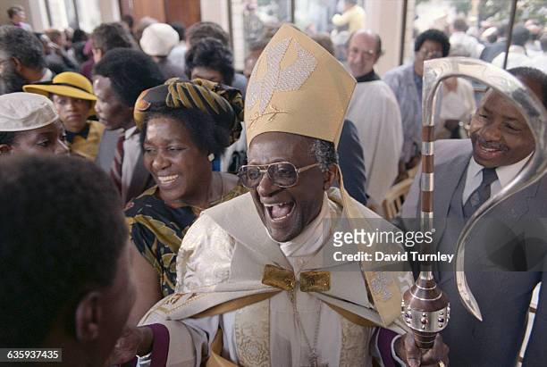 Desmond Tutu smiles after being appointed Anglican Archbishop of Cape Town in 1986. His wife, Leah, is at his side.