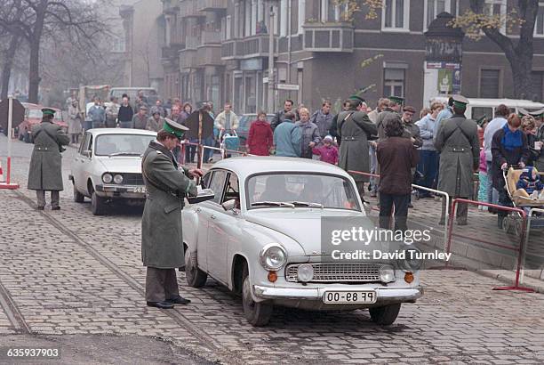 East Germans pass through a checkpoint into West Berlin after the opening of the Berlin Wall.