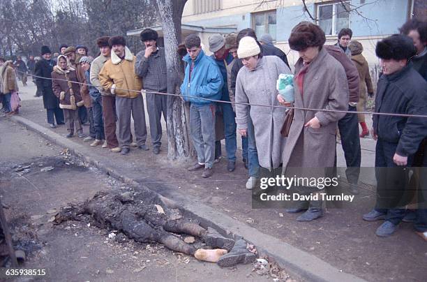 Romanians Looking at Burnt Corpse