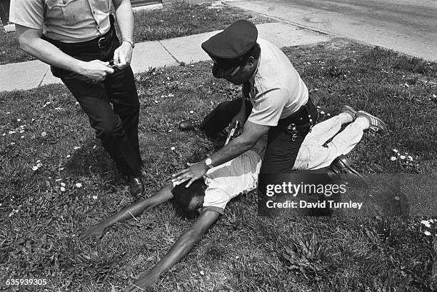 Police Officer Detaining a Gang Member