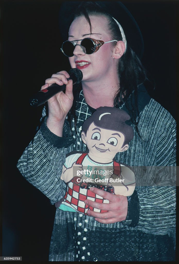 Boy George Singing with Doll