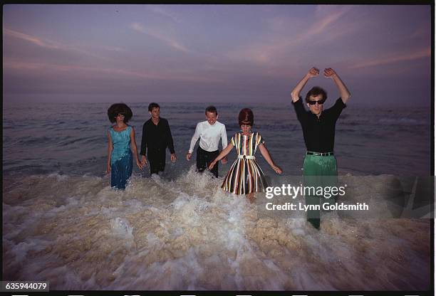 The members of the rock/new wave group the B-52s stand knee deep in the ocean. From left to right: Cindy Wilson, guitar and vocals; Keith Strickland,...