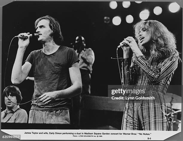 James Taylor and wife Carly Simon sing a duet at the "No Nukes" concert in Madison Square Garden.