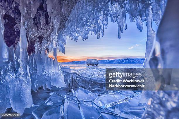 ice cave at baikal lake, russia - ijspegel stockfoto's en -beelden