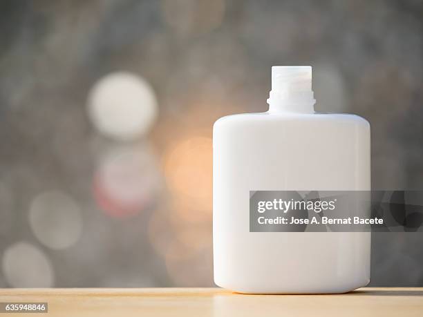 blank cosmetics containers, close up, aftershave lotion , illuminated by sunlight - aftershave bottle stock pictures, royalty-free photos & images