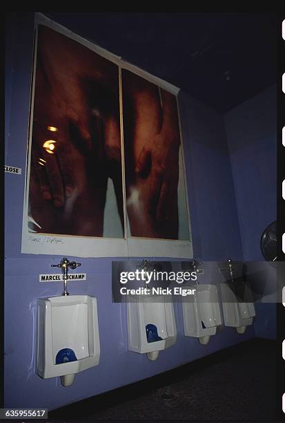 Photograph display by Chuck Close decorates the men's restroom at Area, a Manhattan nightclub.