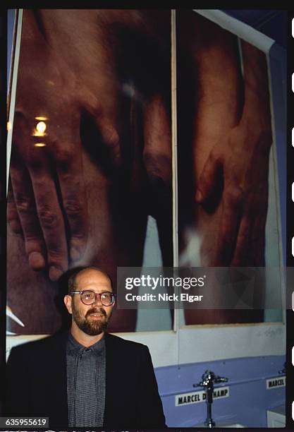 Chuck Close with his photograph display in the men's restroom at Area, a Manhattan nightclub.