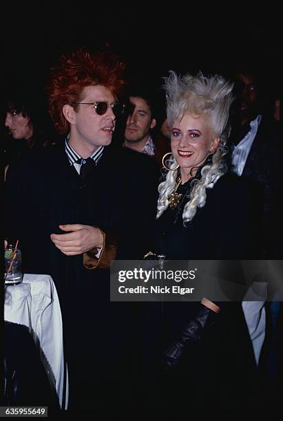 Tom Bailey and Alannah Currie of the Thompson Twins sit together.