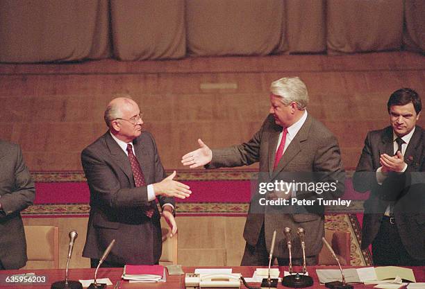 Soviet leader Mikhail Gorbachev and Boris Yeltsin shake hands during a meeting after the failed coup d'etat in 1991.