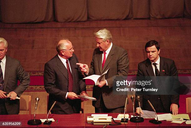 Soviet leader Mikhail Gorbachev and Boris Yeltsin talk with each other during a meeting after the failed coup d'etat in 1991.