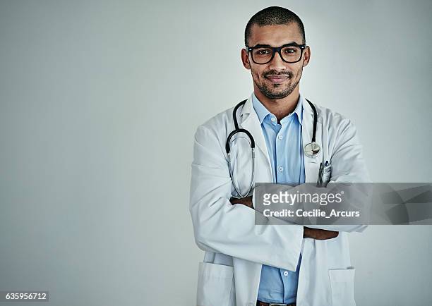 he's one of the top healthcare professionals - doctor looking at camera stock pictures, royalty-free photos & images