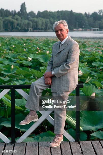 Romanian dictator Nicolae Ceausescu poses casually beside a pond blooming with water lilies at his villa near Bucharest in August 1989. | Location:...