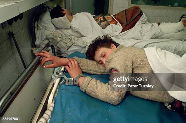 At Bucharest's Emergency Hospital in 1989, a wounded secret police officer from Nicolae Ceausescu's infamous Securitate organization sleeps while in...