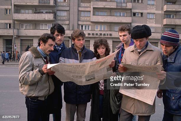 During the revolution of 1989, citizens of Bucharest read newspapers giving accounts of the overthrow of Ceausescu and the old-line Communist...