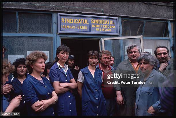 Striking workers from the Urbis Iron Works in Bucharest gather outside the factory.