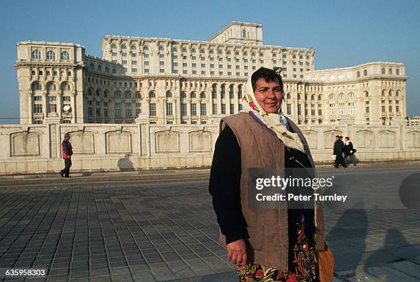 Gypsy woman from Bucharest stands outside the huge House of the People. The massive palace was dictator Nicolae Ceausescu's last and largest project.