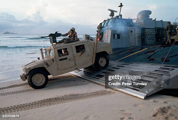 United States Marines drive a multipurpose vehicle onto the sand during an amphibious landing on a Somali beach in December of 1992. In the 1980s a...