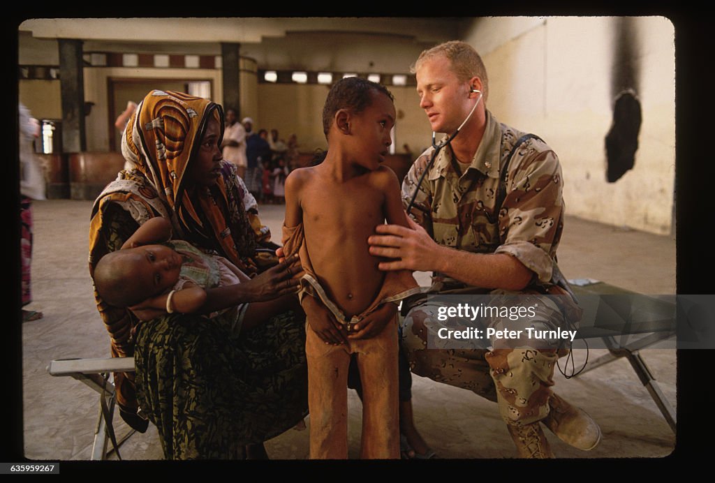 Military Doctor Treating a Somali Child