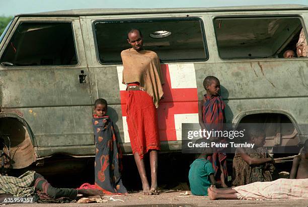 Starving Somalis lean against an abandoned American military medical vehicle during "Operation Restore Hope". In the 1980s a civil war erupted in...
