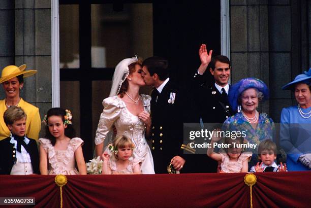 The Duke and Duchess of York and their wedding party stand on the balcony of Buckingham Palace after their wedding.