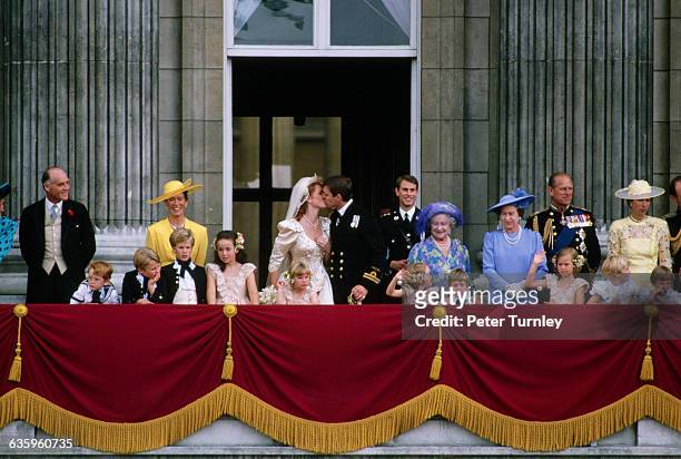The Duke and Duchess of York and their wedding party stand on the balcony of Buckingham Palace after their wedding.