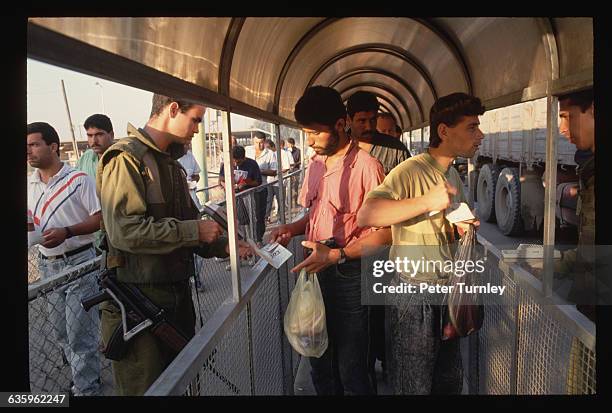 Palestinian workers at the Erez Checkpoint on the Gaza Strip wait to enter Israel. | Location: Border of Israel and Gaza Strip.