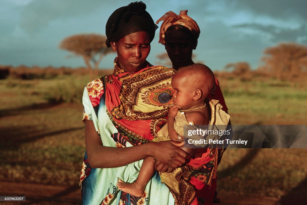 Refugee Mother Holding Infant