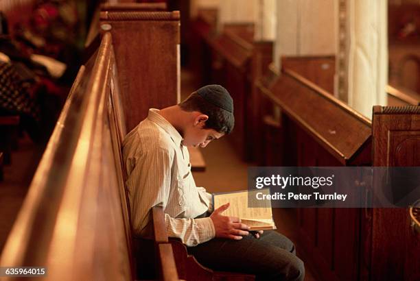 In a Moscow synagogue, a young man reads.