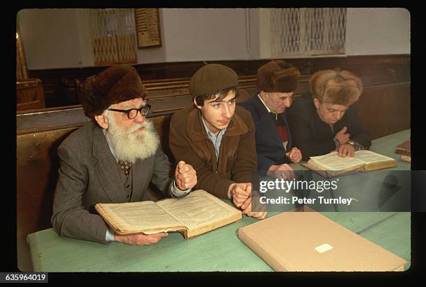 Young man studies with an old man in a synagogue on Arkhipova Street in Moscow.