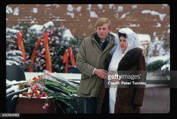 Following Soviet tradition, a newlywed couple visits Lenin's tomb in Moscow.